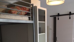 A compact room with a bunk bed, a white cabinet, a dining table, and a chair. - C - Refurbished accommodation / sleeps 4 (Lans-en-Vercors)