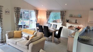 A cozy living room with a sofa and a dining area with a table and chairs.