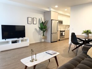 50-inch flat-screen TV with cable channels, TV - Domicile Suites at Venn on Main (Bellevue)