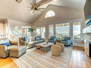 Relax in this inviting living room with a fireplace, sofas, and armchairs arranged around a central coffee table.