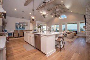 Enjoy meals and social gatherings in this well-equipped kitchen with a large island and ample counter space.