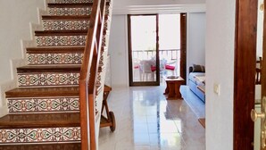 A staircase with ornate tile patterns leading to a balcony area with a view. - Americas II Holiday Home (Playa de las Américas)