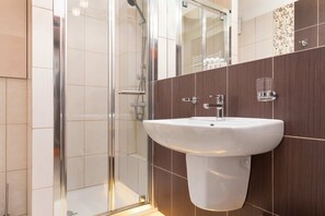 Shower, hair dryer, towels, shampoo