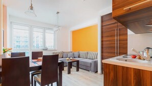 A modern kitchen with wooden cabinets, a built-in oven, and a sink.