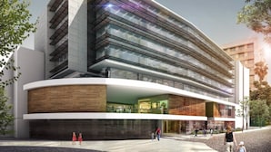 A modern hotel with a curved facade, large glass windows, and a wooden lower section. - Rincon de Granada (Cali)