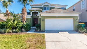 A two-story house with a garage, numbered 2803, surrounded by palm trees and a well-maintained lawn. - Harrys Hide Out by VillaDirect (Kissimmee)