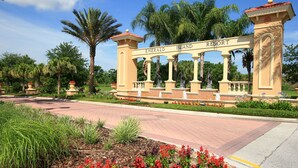 A gated entrance with the words "Emerald Island Resort" on a sign. - Timeless Memories by VillaDirect (Kissimmee)