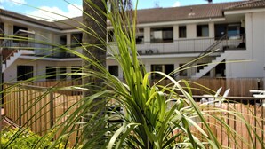 A residential building with a two-story structure, a balcony on the upper floor, and a visible staircase. - Gold Coast Inn (Surfers Paradise)