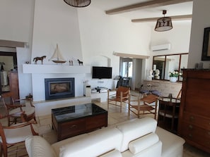 A living room with a fireplace, television, and seating area.