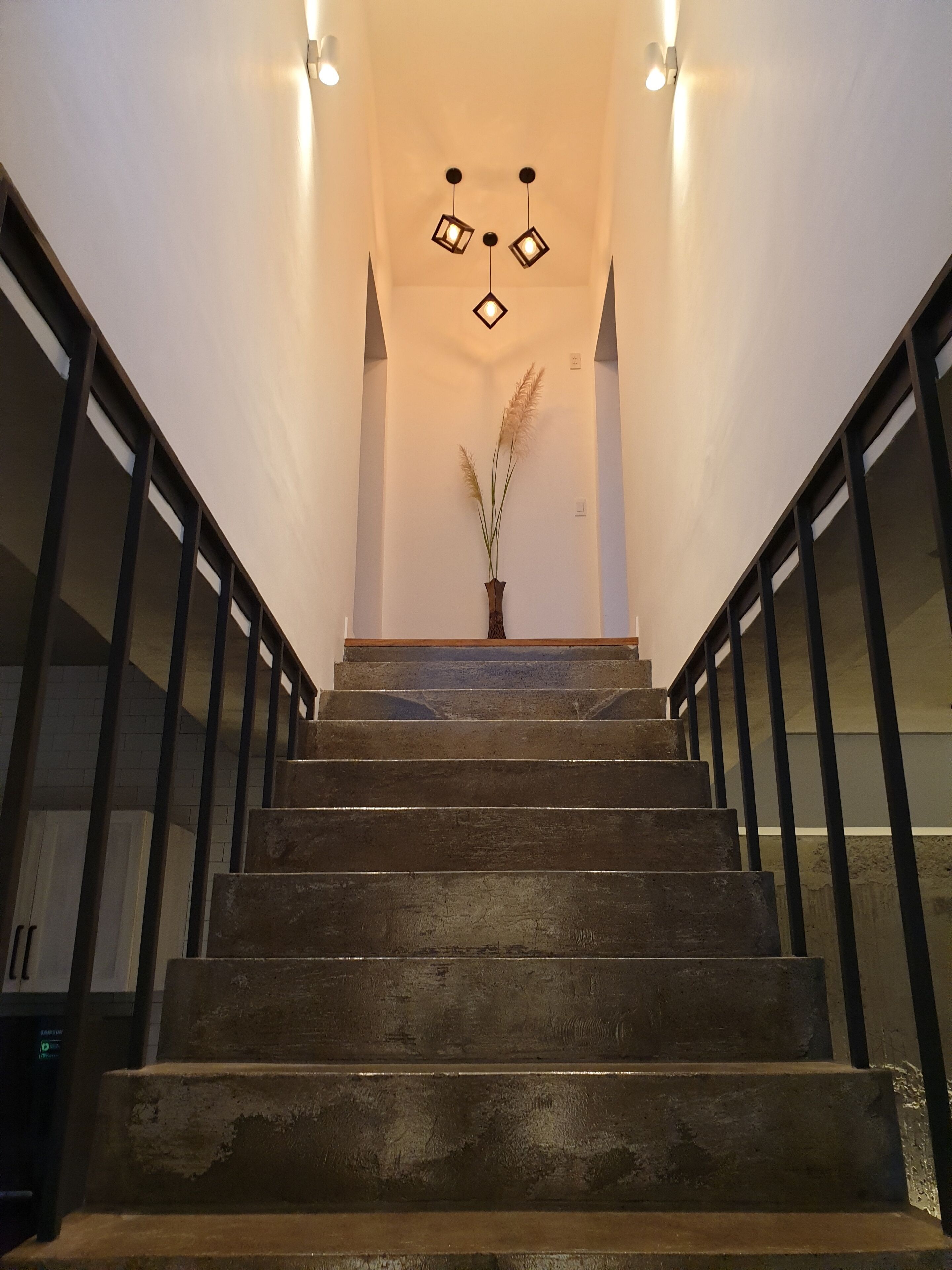 A staircase with a modern design, featuring a wooden finish and metal railings.