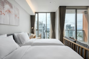 A hotel room with two beds, a city view, and a large window. - Oakwood Suites Bangkok (Bangkok)