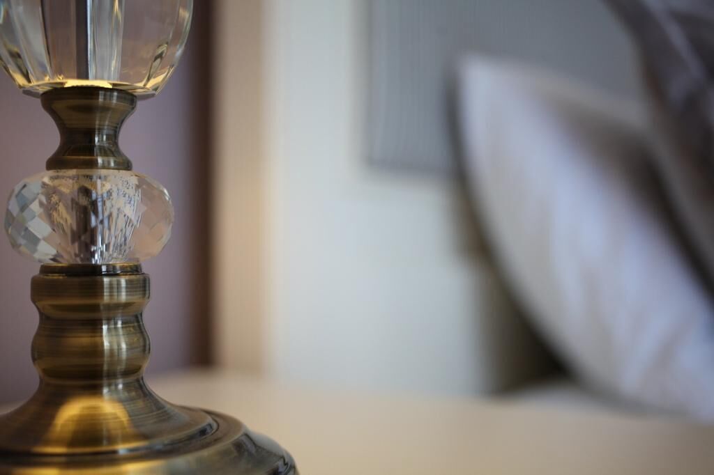 A close-up of a crystal-studded lamp on a table.