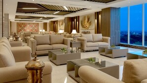 A modern living room with sofas, coffee tables, and decorative lamps. - Aston Gresik Hotel & Conference Center (Gresik)