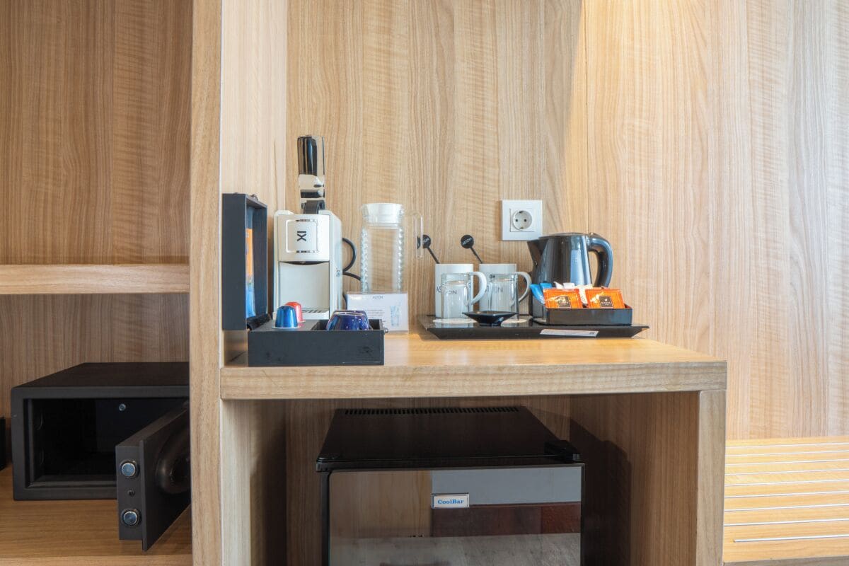 A kitchenette area with a coffee maker, kettle, and microwave.