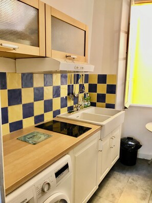A compact kitchen with a dishwasher, a stove, and a sink. - Rental small 3 Pieces Historic Center (Menton)