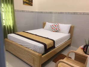 Cozy retreat with a single bed, nightstand, and decorative border.