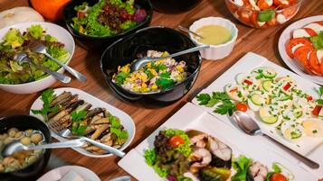 A variety of dishes including salads, seafood, and a bowl of soup.