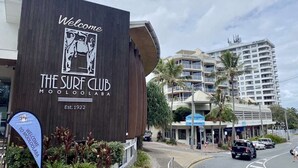 A building with a sign reading "The Surf Club Mooloolaba" and a date "Est. 1922". - Mooloolaba Beachfront Apartment (Mooloolaba)