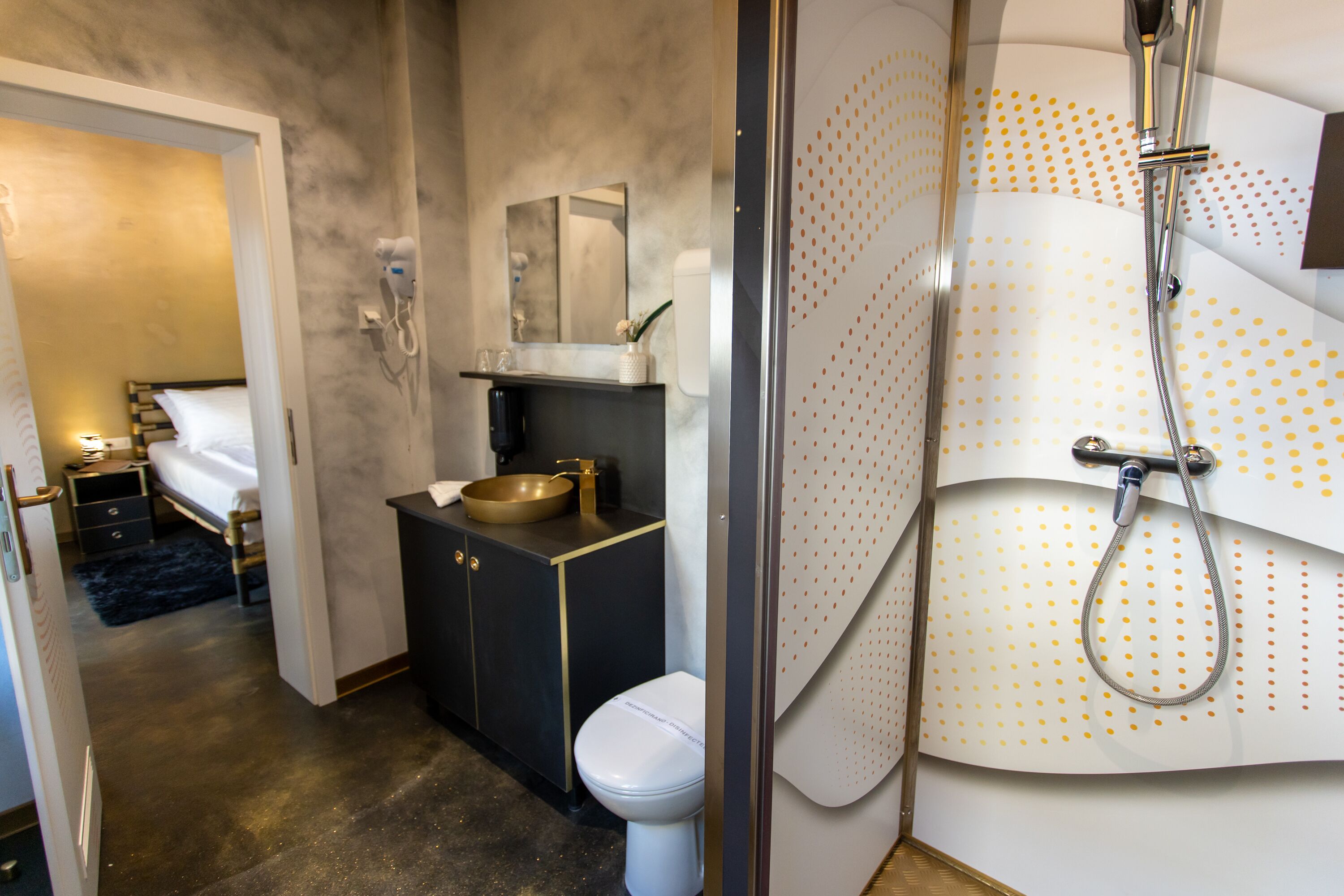 A modern bathroom with a shower, toilet, and sink.