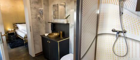 A modern bathroom with a shower, toilet, and sink.