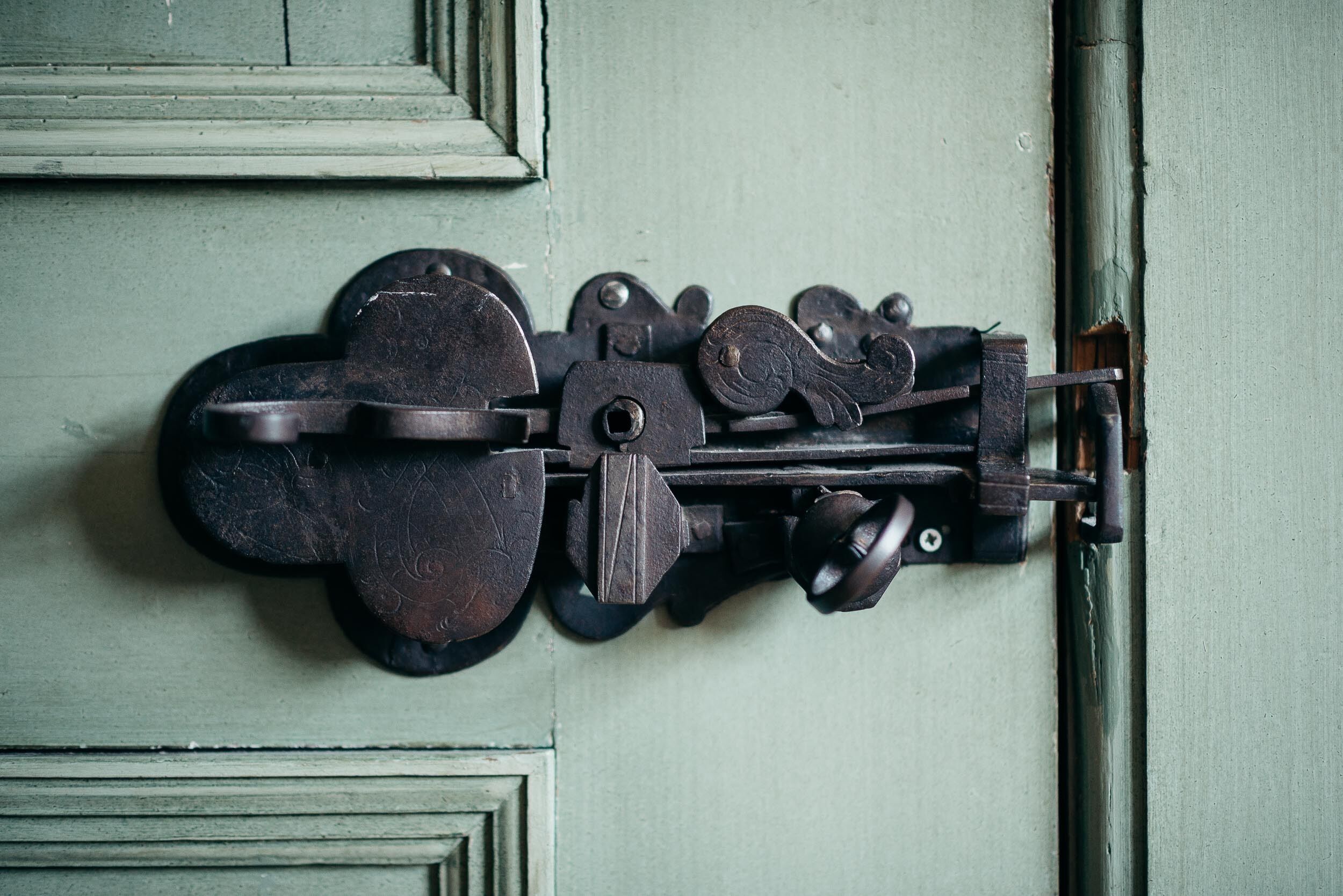 A door with a metal latch mechanism.