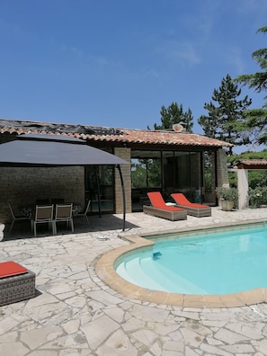 A pool area with stone flooring, a covered seating area, and lounge chairs. - 🌿 Dry stone summer house with private pool - Lincel, Provence (Lincel)