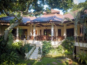 A traditional building with a tiled roof, outdoor seating area, and a staircase leading to an upper level. - Wonderful luxury hideaway surrounded by nature (Seririt)