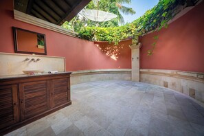 A bathroom with a sink, mirror, and a wooden cabinet. - Wonderful luxury hideaway surrounded by nature (Seririt)