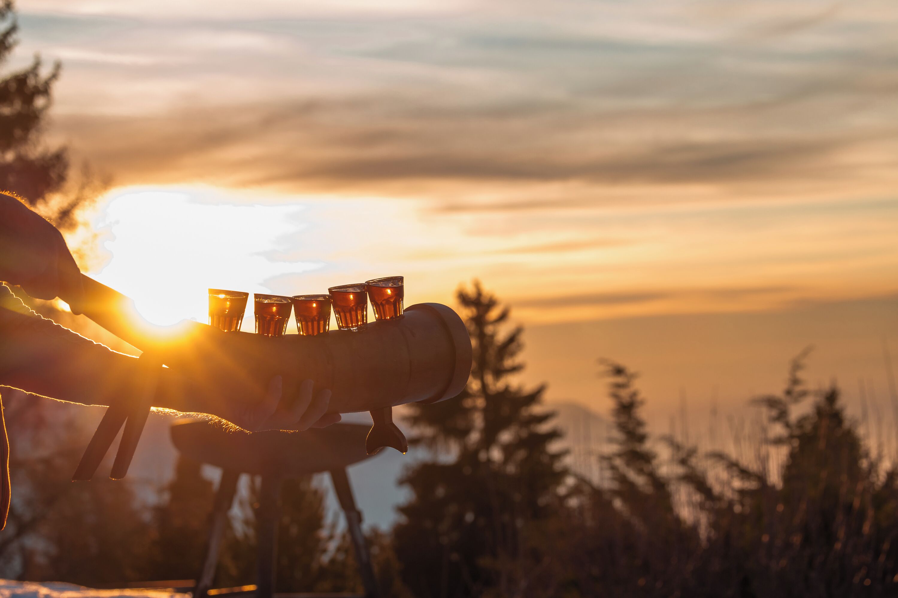 A sunset with a silhouette of a person holding a camera.