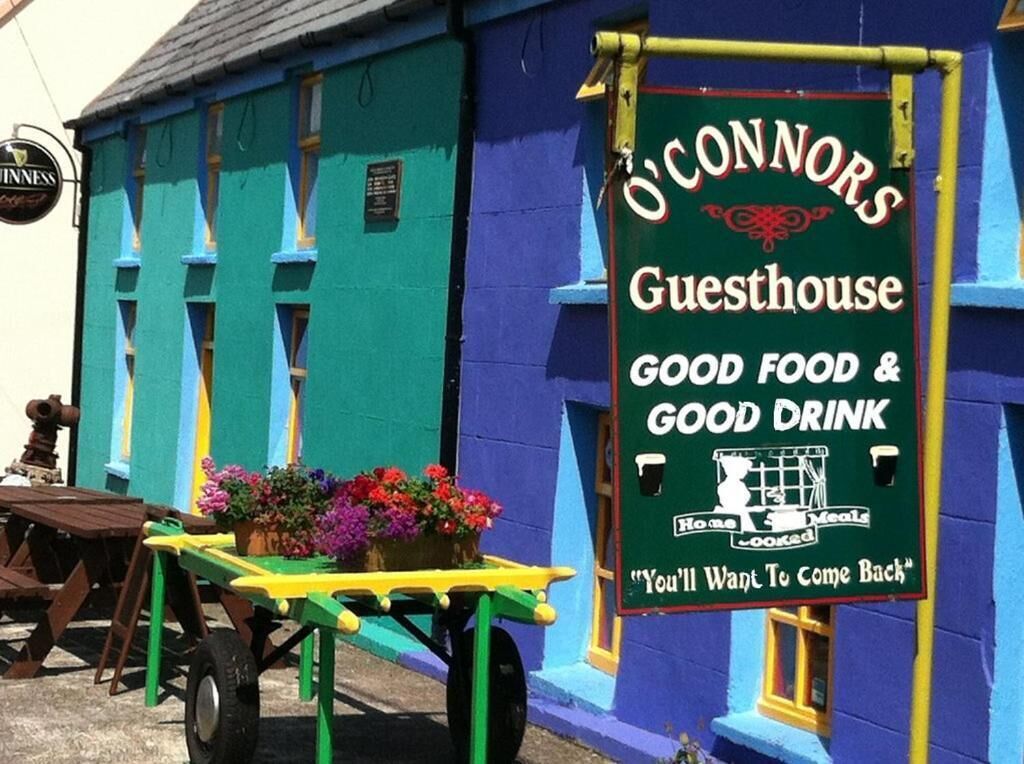 A colorful building with a sign advertising 'O'Connor's Guesthouse' offering 'good food & good drink'.