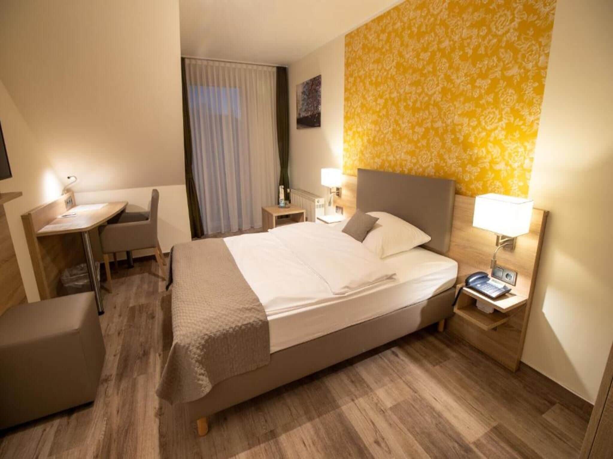 Hypo-allergenic bedding, desk, laptop workspace, blackout curtains