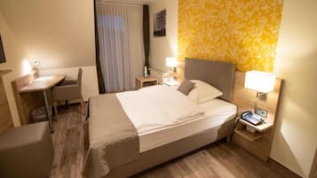 Hypo-allergenic bedding, desk, laptop workspace, blackout curtains