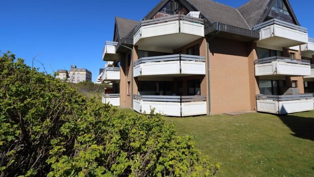 A modern multi-story building with balconies, likely a residential or hotel complex. - Becker House Alice 36 (Sylt)