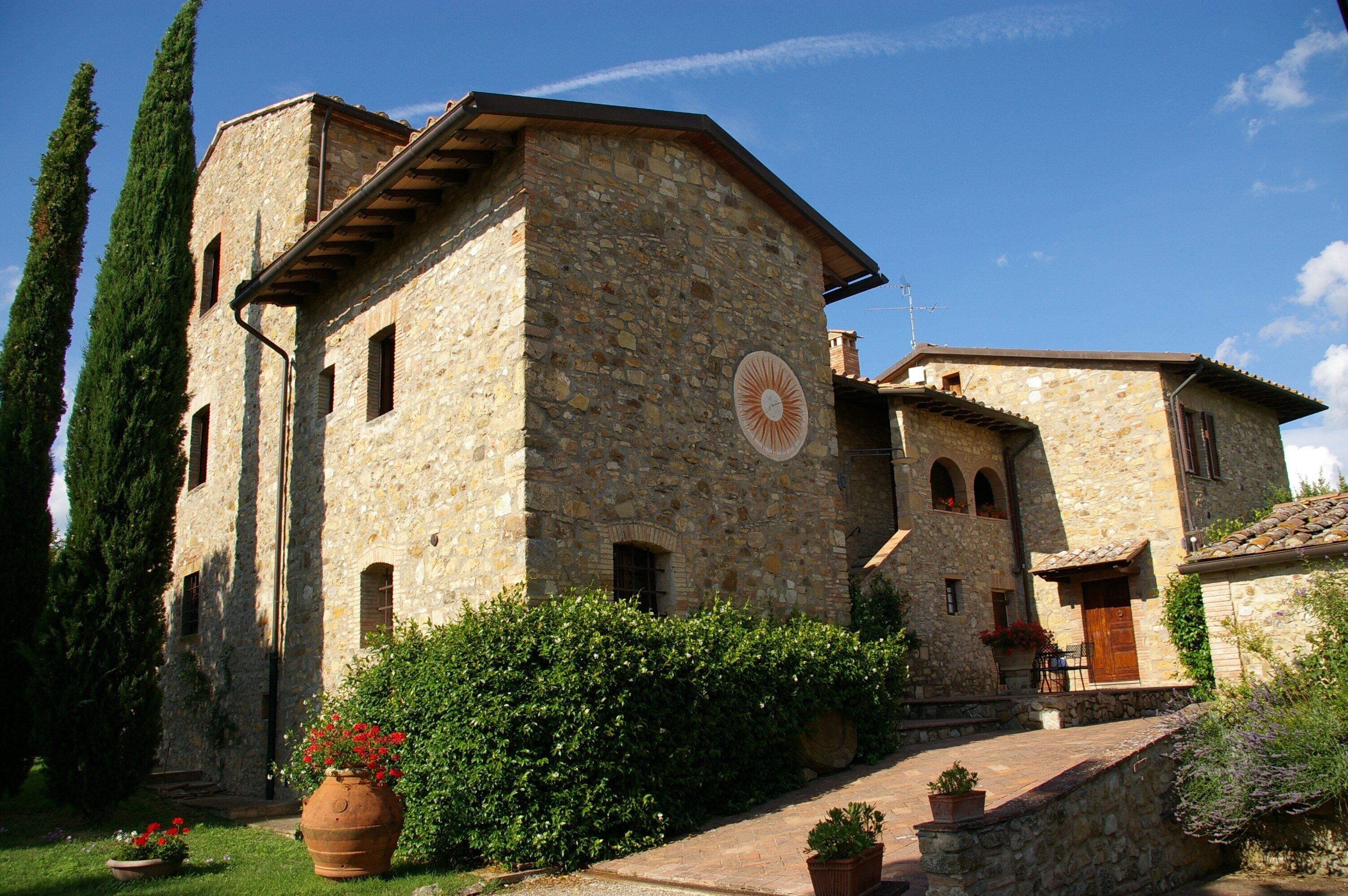 A stone building with a circular window and a door.