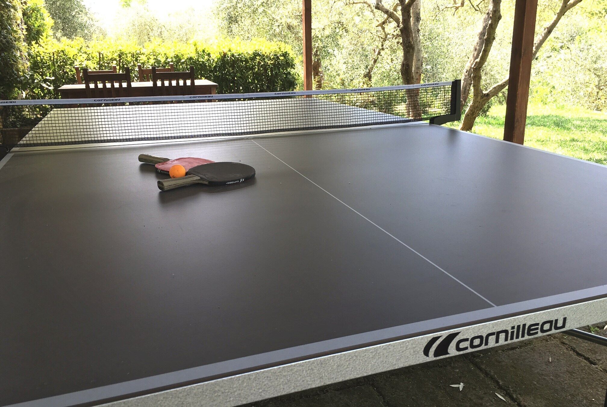 A table tennis table with a net, branded with 'Cornilleau'.