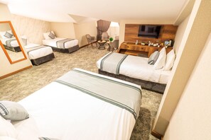 A hotel room with two beds, a desk, a chair, a TV, and a small table with a plant. - Istanbul Airport Express Hotel (Arnavutköy)