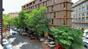 A multi-story building with a modern design, featuring balconies and large windows. - Cavour Square Apartment (Rome)