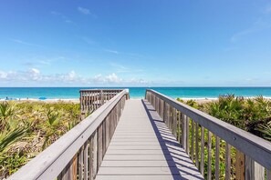 A wooden boardwalk leading to a beach with clear skies. - Oceanfront Paradise!  Private Beach + Golf, Tennis, Pickleball, Hot Tubs Access (Stuart)