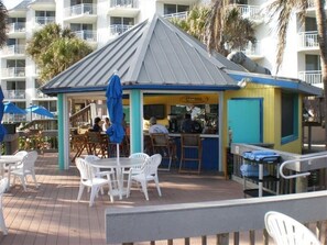 Enjoy a refreshing drink at our outdoor bar, surrounded by comfortable seating and a lively atmosphere.