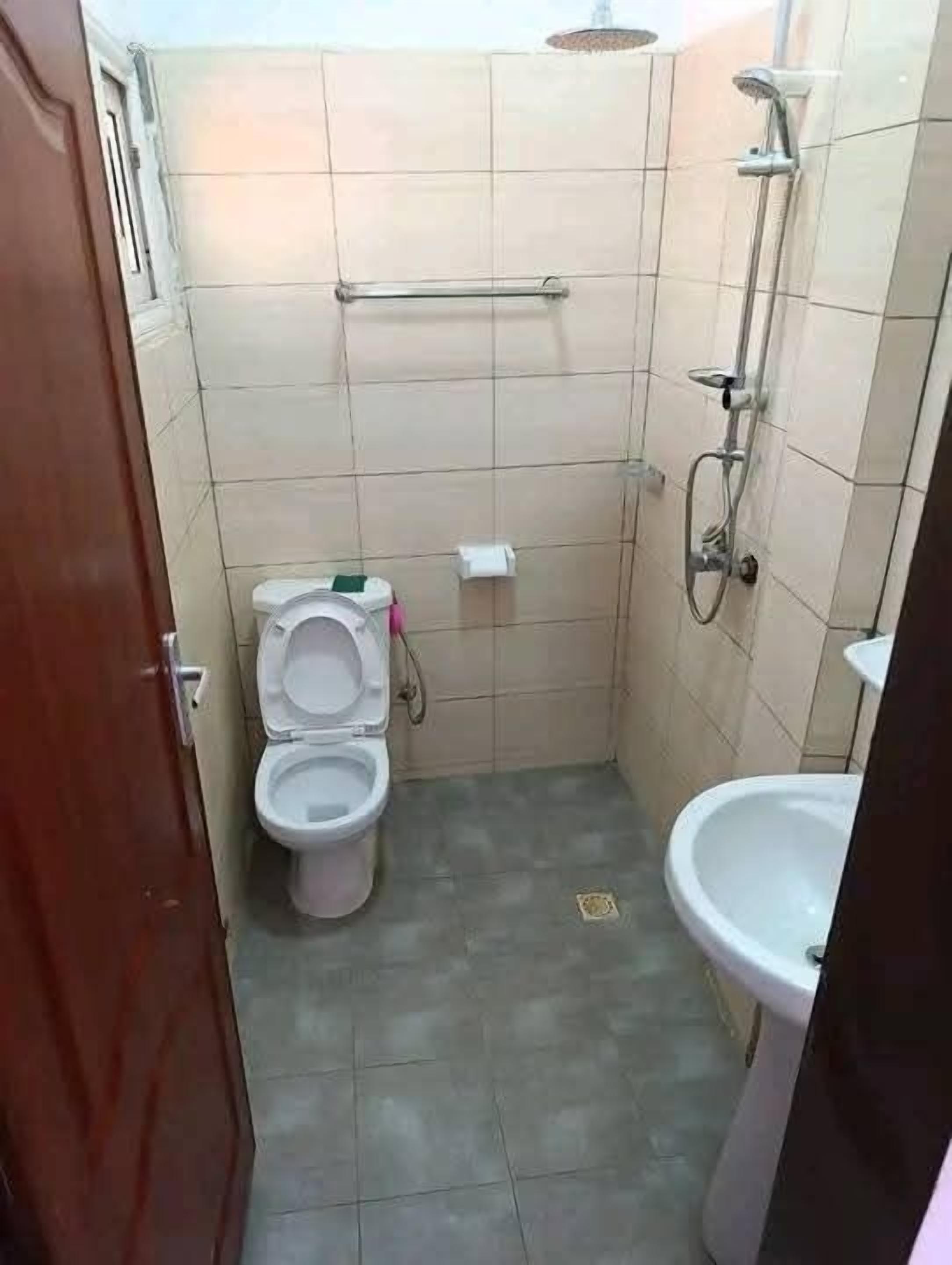 A small bathroom with a toilet, bidet, and shower.