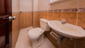 A bathroom with a toilet, sink, and shower area. - Apartment in Cartagena Colombia. (Cartagena)
