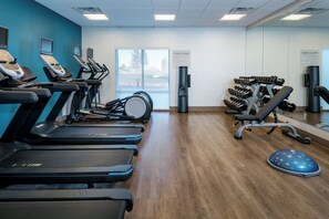 A fitness center with treadmills, a rowing machine, and a weight bench area. - Holiday Inn Express & Suites Bend South by IHG (Bend)