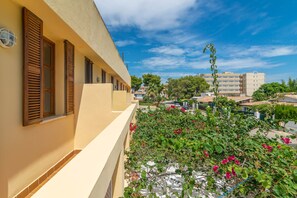 Enjoy a Mediterranean-inspired stay with a balcony offering lush views and vibrant flowers.
