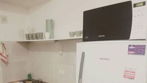 A kitchen with a microwave, a refrigerator, and a sink. - Palermo Soho Apartment 2 (Buenos Aires)