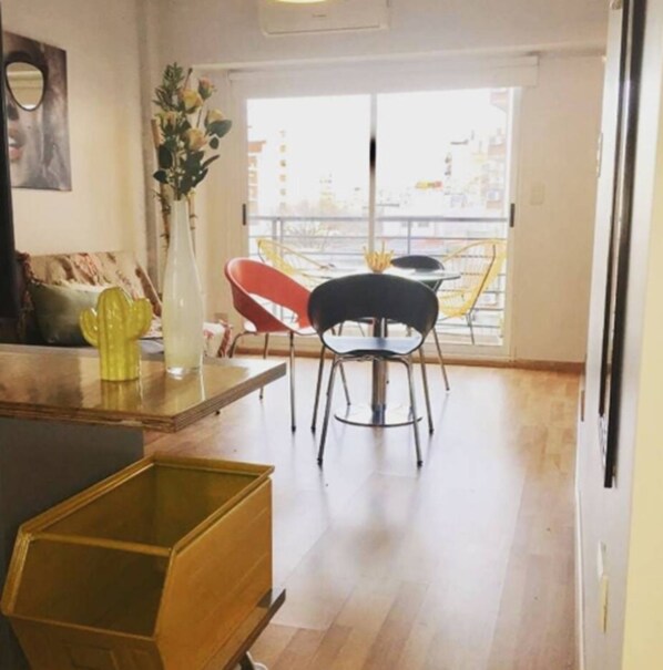 A modern kitchen with a dining area, a large window, and a view of the city.