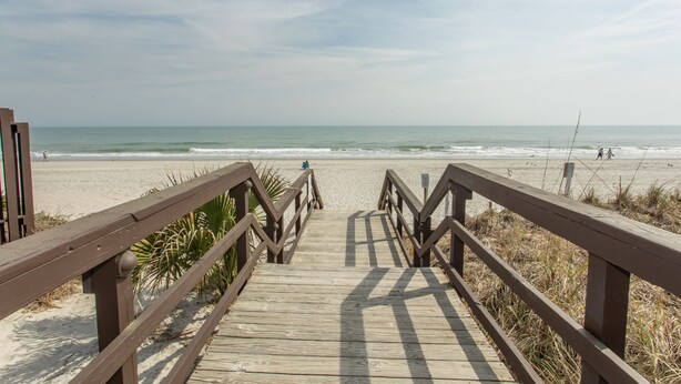 A wooden boardwalk leading to a beach with a clear view of the ocean. - Birdie's Beachfront I - The only Oceanfront Condo to be at Myrtle Beach Resort (Myrtle Beach)