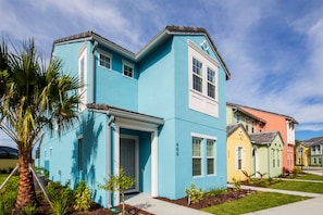 A two-story residential building with a blue exterior, white trim, and a number '405' on the side.