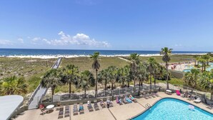 A pool area with lounge chairs and a view of the beach. - Beachfront Gulf Condo! Renovated! Big Savings + Gorgeous Views! (Orange Beach)