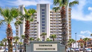 A multi-story building labeled "Tidewater Condominium" with a prominent entrance sign. - Beachfront Gulf Condo! Renovated! Big Savings + Gorgeous Views! (Orange Beach)