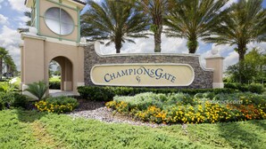 A sign reading "ChampionsGate" with palm trees and a landscaped garden in the foreground. - Moon Valley by VillaDirect (Davenport)